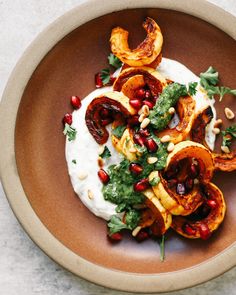 a brown bowl filled with food on top of a table