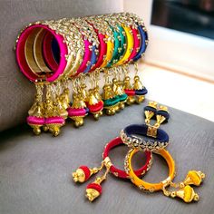 Elevate your style with our exquisite Indian Silk Thread Bangles. Expertly handcrafted with luxurious silk thread and adorned with stunning Kundan bangles, these ethnic bracelets add a touch of elegance to any outfit. Perfect for Indian weddings, these assorted Kangan with Latkan are the epitome of fashion and luxury. Free size for a comfortable fit. Material: Plastic, Silk Thread and Kundan Size: Designed as free size, these bangles offer versatility and ease of wear for women of different wris Gold Silk Thread Bracelets For Diwali, Silk Thread Bangle Bracelets For Festivals, Diwali Silk Thread Bangle Bracelets, Diwali Silk Thread Bangle Bracelet, Handwork Multicolor Bangle Jewelry, Diwali Silk Thread Bangle Jewelry, Multicolor Handwork Jewelry For Diwali, Diwali Silk Thread Bangle, Multicolor Embroidered Bangle Jewelry