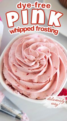 a white bowl filled with pink whipped frosting