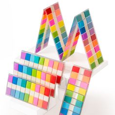 three different colored blocks are stacked on top of each other in order to form the letter m