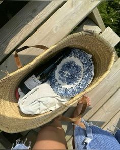 a straw hat with blue and white plates in it