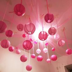 pink lanterns hanging from the ceiling in a room