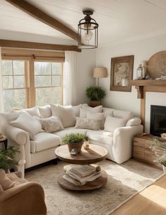 a living room filled with furniture and a fire place under a window next to a fireplace