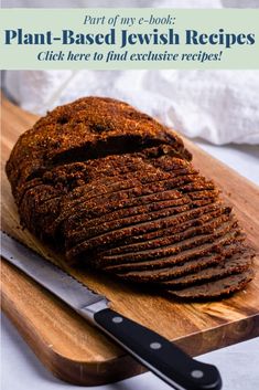 a loaf of bread sitting on top of a wooden cutting board next to a knife