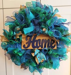 a blue and green wreath with the word home on it