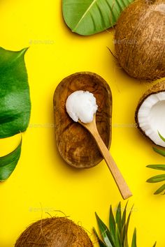 coconuts and leaves on a yellow background with a spoon - stock photo - images