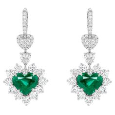 18kt white gold heart shape earrings weighing 8.16 cts; heart and round shape diamond in a halo weighing total of 8.00 ct of white diamonds set all the way around. C. Dunaigre Emerald Heart Earrings, Luxury Heart Earrings With Diamond Accents, Luxury Heart-shaped Diamond Earrings, Luxury Heart Cut Diamond Earrings, Luxury White Gold Heart-shaped Diamond Earrings, Luxury Diamond Earrings For Valentine's Day, Luxury Cubic Zirconia Heart Earrings For Formal Events, Luxury White Gold Diamond Heart Earrings, Luxury Diamond Heart Earrings In White Gold