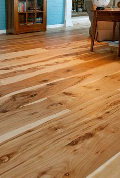 a living room with hard wood floors and blue walls