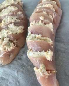 two pieces of meat sitting on top of a table