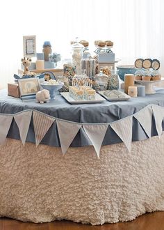 a table topped with cakes and desserts on top of a wooden floor