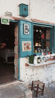 a store front with blue shutters and windows