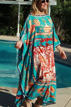 Beautiful turquoise designer print silk caftan (the color photographed more green in the outdoor light, but it is a turquoise color as the second photo shows) . Great for pool, beach, travel or lounging at home or an evening out. One size. Fits small to X-large sizes. The width is 52 inches edge to edge or 104 around the body. The length is 52 inches. Silk Maxi Dress With Vibrant Print For Beach, Blue Bohemian Dress For Pool, Green Vibrant Print Kaftan For The Beach, Green Silk Kaftan For The Beach, Spring Bohemian Turquoise Kaftan, Green Silk Dress For The Beach, Turquoise Maxi Kaftan For Summer, Blue Silk Kaftan For Vacation, Green Silk Maxi Dress For Beach