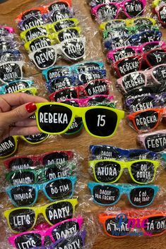 a table topped with lots of sunglasses covered in plastic wrap and stickers that say reebka