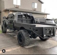 a black truck parked in front of a house