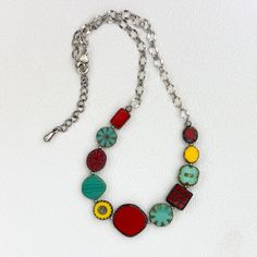 This  colorful necklace is casual and fun.  It is composed of various size, shape, and color Czech glass beads, alternated with antique brass round beads and attached to an antique brass chain.  All components are antique brass including the adjustable lobster clasp.  The necklace ranges 18 1/2" - 20 1/2" in length, and 5/8" wide at the widest point. Multicolor Round Bead Brass Necklace, Multicolor Round Beads Brass Necklace, Multicolor Brass Necklace With Round Beads, Nickel-free Multicolor Beaded Necklaces For Jewelry Making, Vintage Multicolor Necklace With Adjustable Chain, Body Lace, Czech Glass Necklace, Bead Chain Necklace, Boulder Opal Pendant