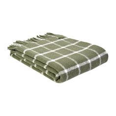 the green and white plaid blanket is folded up