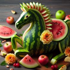 a horse made out of watermelon, apples and other fruits on a table