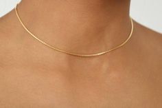 "Dainty, feminine, and minimalist 18k gold-filled choker. The perfect piece to layer with your favorite crystal necklace.   NO TARNISH  C H A I N  L E N G T H  14 inches  A 14\" chain fits like a choker and is perfect for necks not bigger than 12.5\".  18K  G O L D  F I L L E D   These chains are 18k gold-filled. 18k gold-filled jewelry is created with a thick layer of 18k solid gold over a metal core. Gold-filled jewelry is a beautiful and affordable alternative to solid gold. It is an excellen Minimalist Box Chain Choker, Minimalist Yellow Gold Choker With Adjustable Chain, Dainty Jewelry With Curb Chain, Dainty Gold Chain Choker, Dainty Gold Chain Choker Jewelry, Minimalist 14k Gold Filled Choker, Elegant Curb Chain Choker Gift, Minimalist Gold Chain Choker, Minimalist Everyday Gold Chain Choker