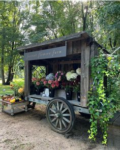 an old wooden cart with flowers in it