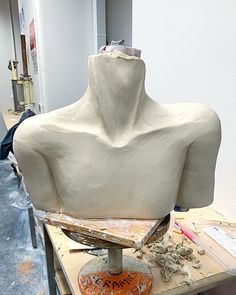 a white sculpture sitting on top of a wooden table