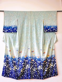 the vintage Japanese obi belt, kimono. One by one, made by hand, the only one of its kind in the world. This is an original Japanese vintage kimono. It fits any size and is perfect for spring, winter, autumn as it is an unlined Hitoe Kimono. We sell only kimonos. The obi and obijime used in the photo are not included. It is cleaned and in very good vintage condition. Like new Details 👘 Check the last picture ⇒Condition sheet Why should you by from us? Our Kimonos have a history and a story to tell. They are original Japanese vintage and therefore of the finest quality and sustainable on top. We clean our kimonos to get rid of the dust and smell of the past and make them ready to wear. Because that's the way we would like to buy them! *The colours on your screen might differ slightly from Traditional Blue Floral Print Kimono, Traditional Blue Floral Kimono, Blue Kimono For Spring Tea Ceremony, Blue Silk Kimono For Wedding, Blue Silk Wedding Kimono, Blue Kimono With Kimono Sleeves For Tea Ceremony, Traditional Blue Kimono For Tea Ceremony, Traditional Long Blue Kimono, Vintage Floral Print Kimono For Wedding