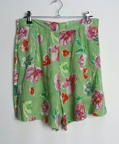 "a vintage pair of high-waisted green and pink floral pattern shorts with buttons all the way up the left side ✿ IMPORTANT INFORMATION: * excellent vintage condition * material: 100% viscose * size: small - please check exact measurements below (they're there for your benefit!) * garment care: machine washable * made in belgium ✿ MEASUREMENTS (taken while item is lying flat, some measurements will need to be doubled): * waist: 14\" (36cm) * hips: 25\" (64cm) * front rise: 14.5\" (37cm) * back ri Green High-waisted Summer Shorts, High Waist Green Summer Shorts, Summer Green High-waist Shorts, Spring Green Bermuda Shorts With Built-in Shorts, Green Floral Print Cotton Bottoms, Green Cotton Bottoms With Floral Print, Fitted Floral Print Shorts, High Waist Green Bermuda Shorts For Summer, Green Bermuda Shorts For Spring