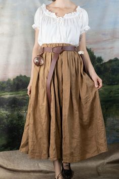 This skirt is made from a beautiful shade of ginger brown 100% linen fabric that is soft, breathable and drapey. Linen is the historically accurate choice for historical costumes, and this will add a level of authenticity to your outfit.  An elastic waistband gives the skirt a comfortable fit around your natural waist. This skirt features and elastic waistband for a comfortable fit around your waist. The length is made custom to any length you’d like. Please provide your natural waist meas Fall Daywear Skirted Bottoms, Fitted Maxi Skirt With Wide Waistband For Spring, High-waisted Skirt With Waistband, Solid Color High Waist Skirt With Waistband, Solid High-waist Skirt With Waistband, High Waist Skirt With Waistband For Spring, Fitted Belted Flared Skirt, Fitted Belted Flared Skirt Bottoms, Solid Maxi Skirt For Daywear