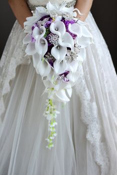 a bridal holding a white and purple bouquet