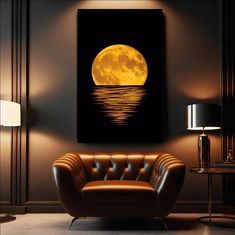 a living room with a couch and chair in front of a large yellow moon over the water