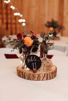 the centerpieces were placed on top of wood slices and decorated with greenery