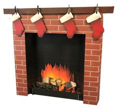 a brick fireplace with stockings hanging over it's mantle and logs on the fire