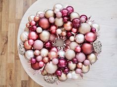 a white table topped with christmas ornaments on top of wooden floored floors next to a bottle opener