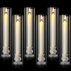 four white candles are lined up in a row