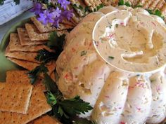 a platter filled with crackers and dip