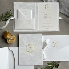 the wedding stationery is white and gold