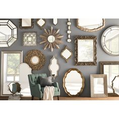 a living room filled with lots of mirrors on the wall above a chair and table