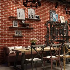 a dining room with brick walls and wooden tables, chairs and pictures on the wall