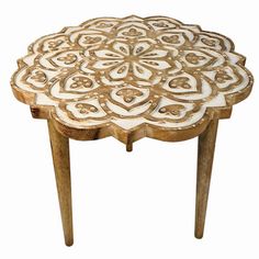 a wooden table with an intricate design on it's top and legs, against a white background