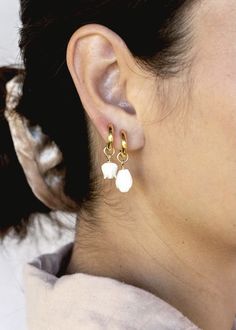 The Lei Hoops reflect Hawaii's natural abundance and beauty. These small gold mother of pearl and gold huggie hoop earrings feature darling carved seashell flower charms reminiscent of Hawai'i's flower leis. These pretty gold hoops are perfect solo or teamed with our some huggie hoops.Handmade on Maui, Hawaii. ✦ Choose from two flower styles: Tulip or Pikake ✦✦ DETAILS ✦✧ Name: Lei (LAEE) - garland.✧ 18kt Gold Vermeil.✧ 25mm & 29mm Drop Length✧ 12mm hoop outer diameter, 9mm inner diameter, & 2.5 Hoops With Charms, Simple Gold Earrings, Gemstone Hoop Earrings, Seashell Earrings, Mother Of Pearl Earrings, Gold Pearl Necklace, Pearl Hoop Earrings, Initial Jewelry, Gold Filled Earrings