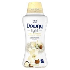 downy light deodorant with white flowers and coconuts on the side