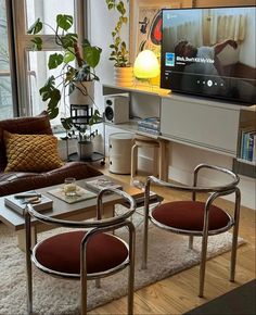 a living room filled with furniture and a flat screen tv