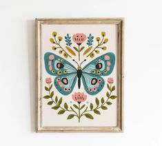 a butterfly painted on top of a white wall next to a wooden framed artwork piece