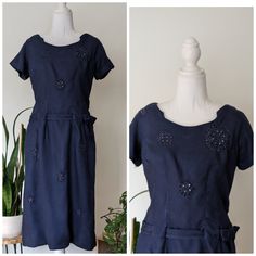 "This 1940s navy blue dress is adorned with embroidered flowers with small gems attached. Perfect party dress, tea dress, day dress! I love the details on the neckline and dropped waist belt that weaves thru dress and attaches with a bow detail.   Era: 1940s Brand: no tag. Side and back metal zipper  Size:  see measurements for best fit  Measurements: B 18\" ptp;  W 15\" flat; Hip where belt sits 16\" flat; lower hip 18 1/2\" flat; L 40\"  Fabric: cotton Condition: Very good.. Ready to wear. Item has been washed and air dried  ** Flaws: loose threads on one embroidery flower and belt has been temp shortened with safety pins and snaps (Easily undone) Function: side zip and back shorter zipper Please feel free to ask questions to ensure best fit. This is a vintage piece and as such will have Navy Sheath Dress, Navy Blue Dress, Day Dress, Navy Blue Dresses, Metal Zipper, Dress Party, Tea Dress, Perfect Party, Bow Detail