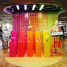 an assortment of colorful clothing on display in a store