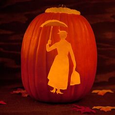 a carved pumpkin with a silhouette of a woman holding an umbrella on it's head