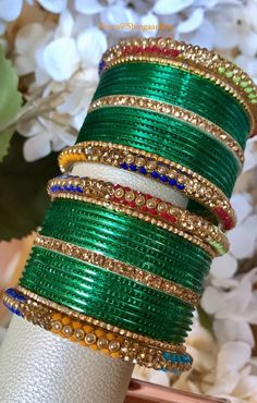 Beautiful simple yet elegant bangle set.  Only available in size 2.4 only.  You will receive 24 green bangles, 4 side bangles and 6 accent bangles as shown in images. Color, shades, texture displayed may slightly vary from the actual product due to digital image limitations. Care: It is advisable that you keep our products away from direct heat, humidity, and moisture.  Please do not use Perfume/spray on the products. We at ShingaarBox doing our best to keep all our products clean and sanitized.  Thank you for your business and stay safe. Festive Green Stone Work Jewelry, Green Jewelry With Stone Work For Diwali, Bohemian Jewelry With Zari Work For Festive Season, Bohemian Jewelry With Zari Work For Diwali, Green Bollywood Jewelry For Festive Season, Green Bangle Bracelets For Wedding, Green Metal Bracelets For Festive Occasions, Green Bollywood Jewelry With Stone Work, Green Round Bollywood Jewelry