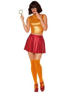 a woman in a gold top and red skirt holding a magnifying glass with both hands