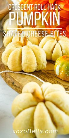 crescent roll hack pumpkin shaped cheese bites on a cutting board with flowers in the background