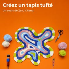 an orange background with yarn, scissors and balls of yarn on it that are laying next to each other