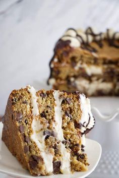 a piece of cake on a plate with a fork next to it and another slice in the background